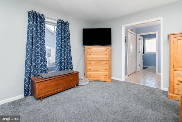 carpeted bedroom featuring multiple windows