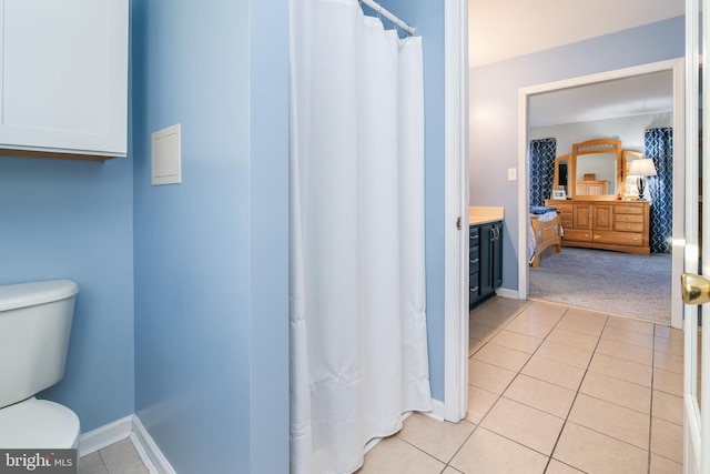 bathroom featuring tile patterned floors, vanity, and toilet