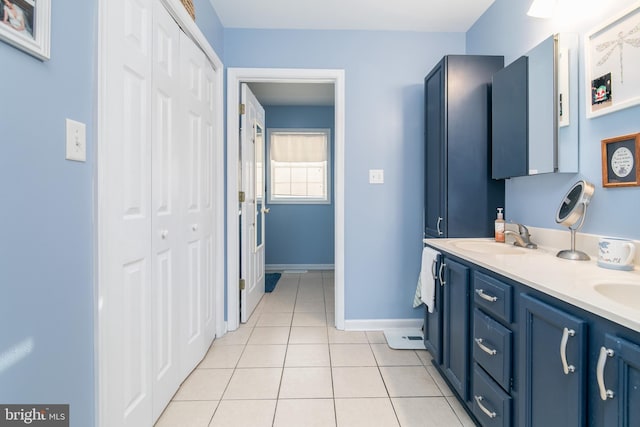 bathroom with tile patterned flooring and vanity