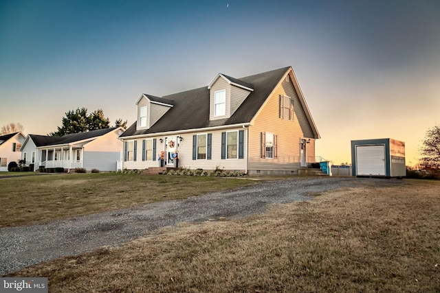 new england style home with an outbuilding and a lawn