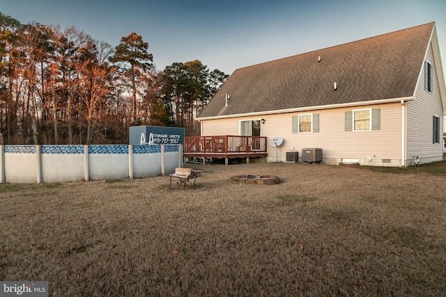 back of house with a swimming pool side deck, a yard, and cooling unit