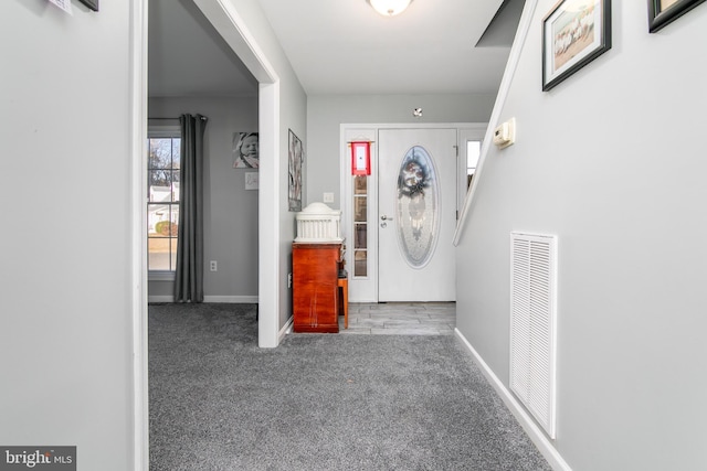 view of carpeted foyer entrance