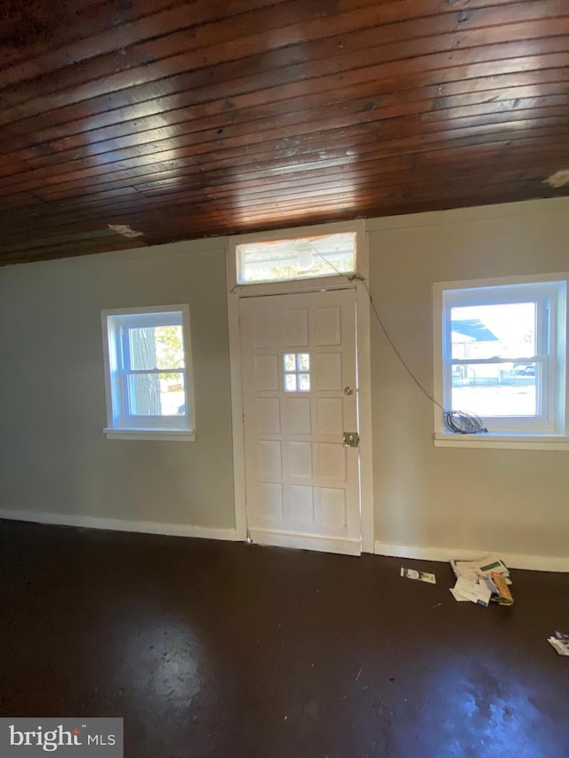 entryway with a healthy amount of sunlight, wooden ceiling, and concrete floors