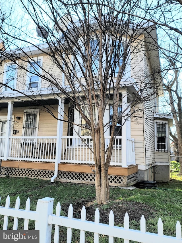 view of side of home with covered porch