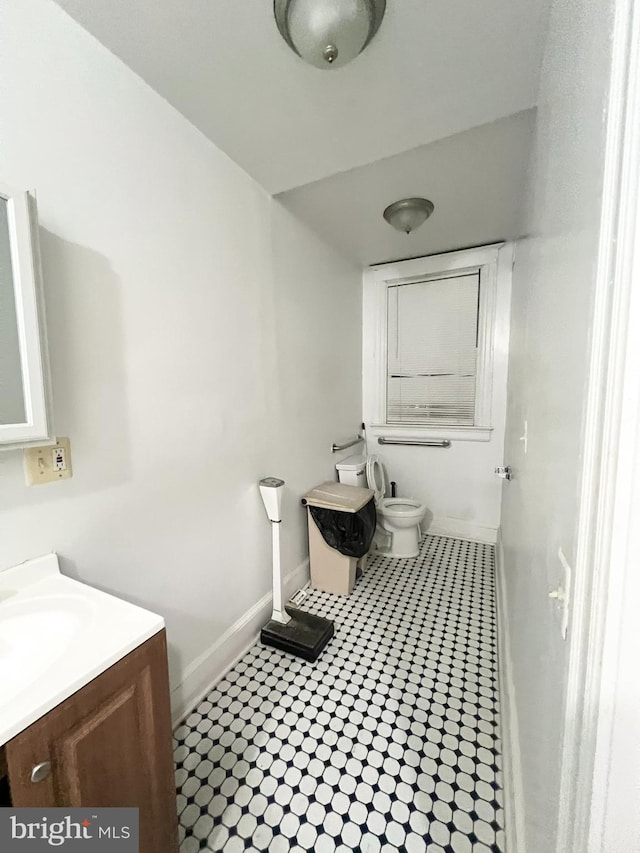 bathroom with tile patterned floors, vanity, and toilet