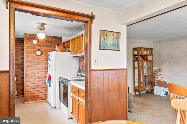 kitchen with electric range and wooden walls