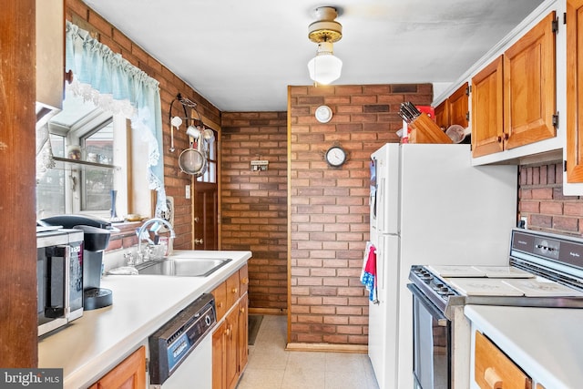 kitchen featuring stainless steel range, white dishwasher, brick wall, and sink