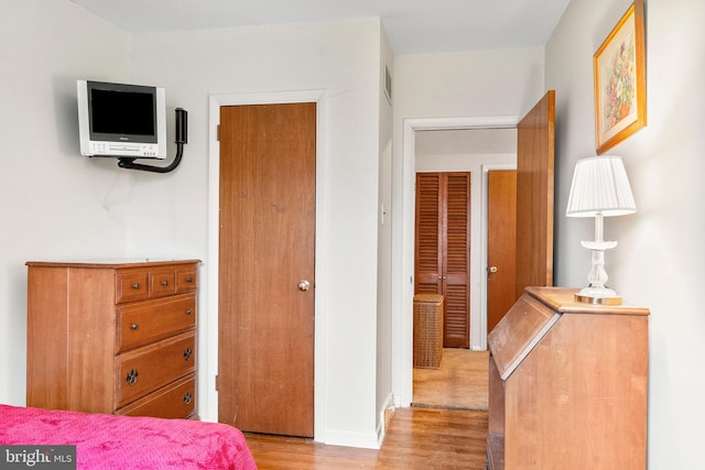 bedroom featuring light hardwood / wood-style floors and a closet