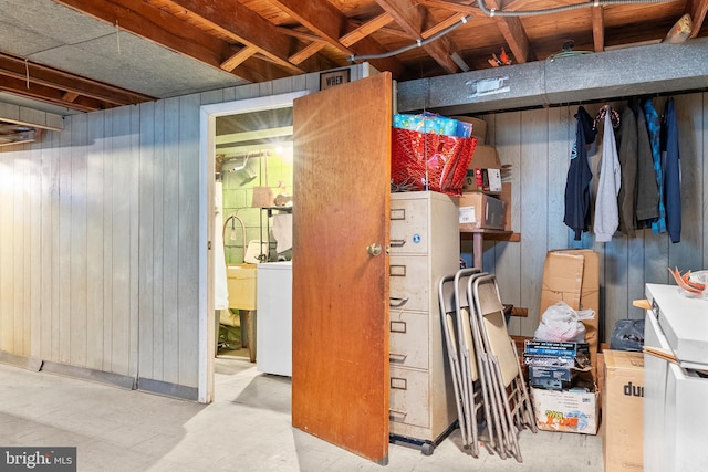 basement featuring wooden walls