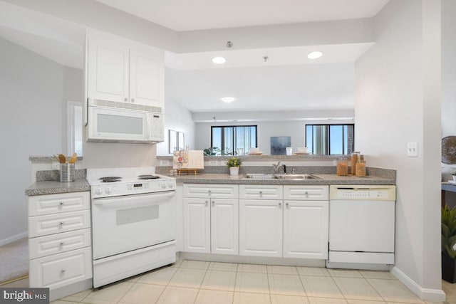 kitchen featuring white appliances, white cabinets, and sink