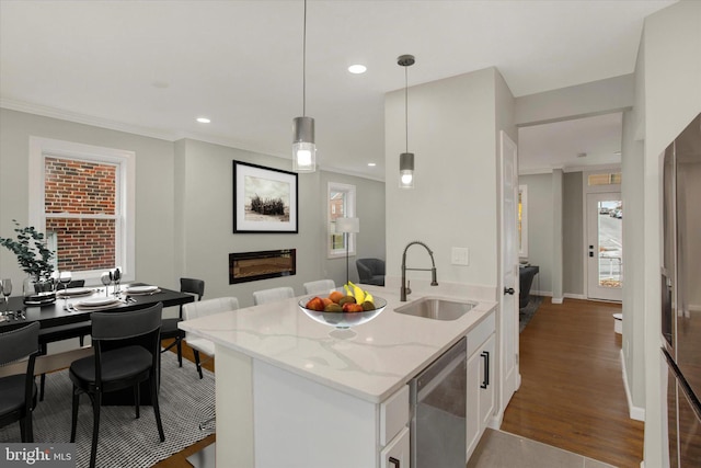 kitchen with white cabinetry, a wealth of natural light, sink, and stainless steel dishwasher