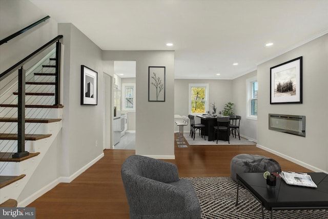 interior space featuring hardwood / wood-style floors, a wall mounted air conditioner, and crown molding