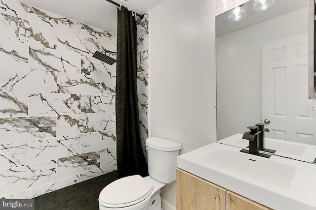 bathroom featuring a textured ceiling, vanity, toilet, and curtained shower