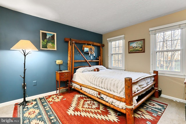 carpeted bedroom featuring a textured ceiling