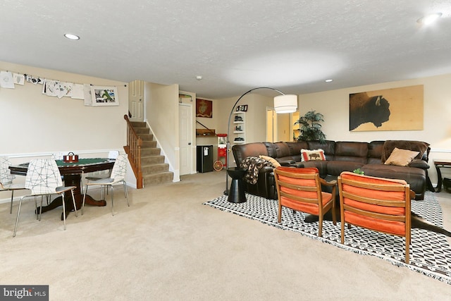 living room featuring light carpet and a textured ceiling