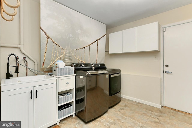 washroom with cabinets, separate washer and dryer, and sink