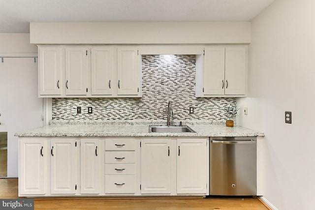 kitchen featuring dishwasher, light hardwood / wood-style floors, decorative backsplash, and sink