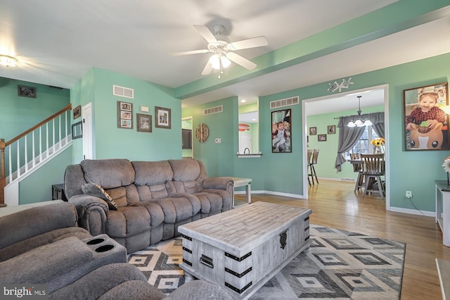143 Mayor Ln, Felton, DE 19943 - living room with stairs, wood finished floors, ceiling fan, and a chandelier