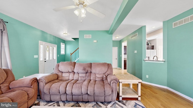 143 Mayor Ln, Felton, DE 19943 - living room with stairs, wood finished floors, and a ceiling fan