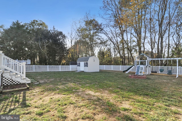 143 Mayor Ln, Felton, DE 19943 - fenced backyard featuring a playground, a storage shed, and view of wooded area