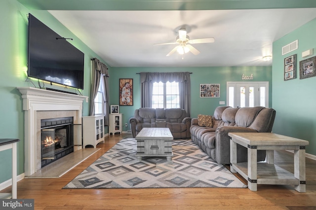 143 Mayor Ln, Felton, DE 19943 - living area with a ceiling fan, wood finished floors, and a tile fireplace