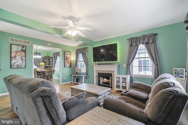 143 Mayor Ln, Felton, DE 19943 - living room with a ceiling fan, a lit fireplace, and wood finished floors