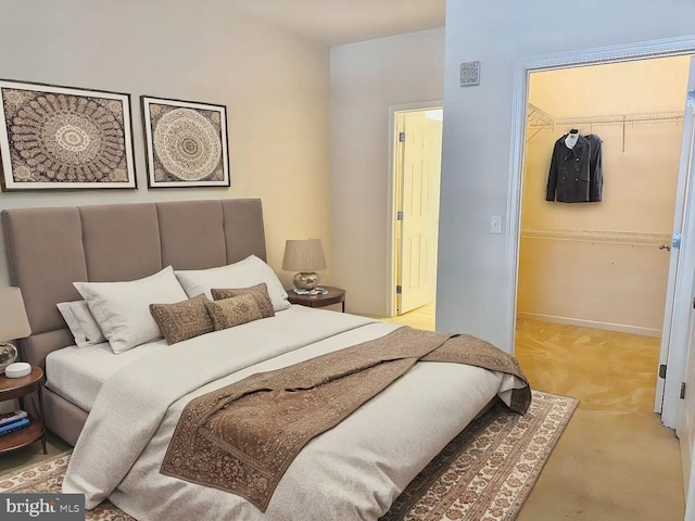 bedroom featuring a walk in closet and a closet