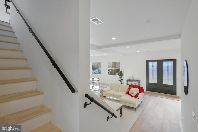 interior space featuring light wood-type flooring and french doors