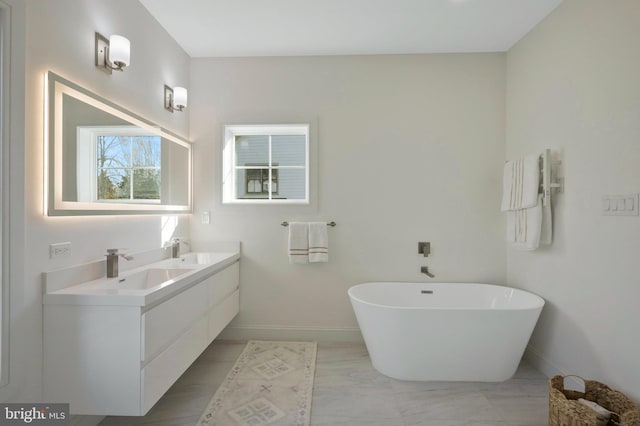 bathroom featuring vanity and a bath