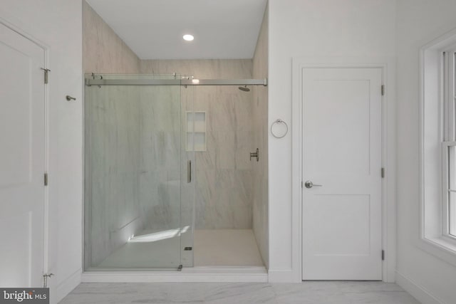 bathroom with a shower with shower door