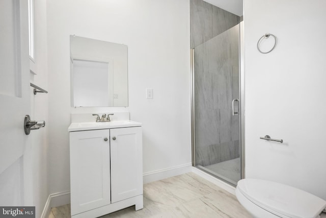 bathroom with vanity, toilet, and a shower with shower door