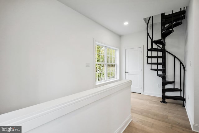 hallway with light hardwood / wood-style flooring