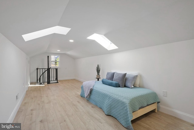 bedroom featuring light hardwood / wood-style flooring and lofted ceiling