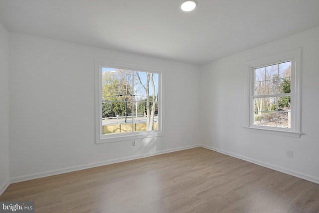 empty room with light hardwood / wood-style flooring