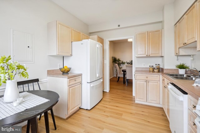 kitchen with sink, light brown cabinets, electric panel, light hardwood / wood-style floors, and white appliances