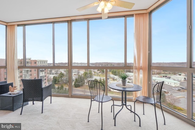 sunroom featuring ceiling fan