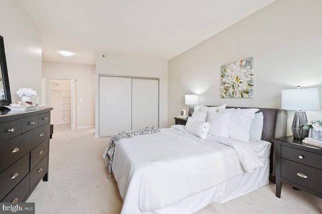 bedroom featuring light colored carpet and a closet