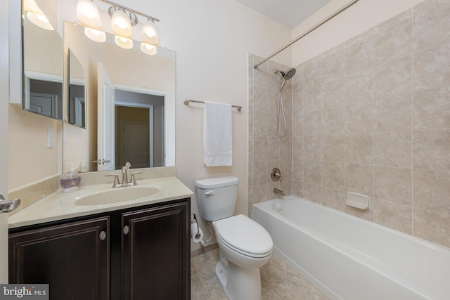 full bathroom with tile patterned flooring, vanity, tiled shower / bath combo, and toilet