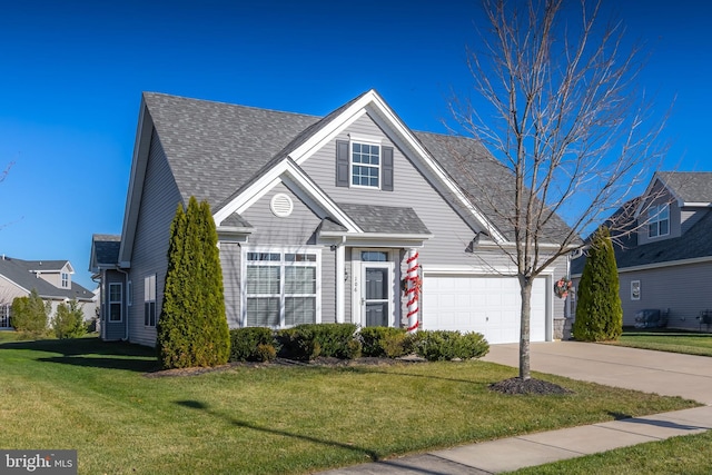 view of property featuring a garage and a front lawn