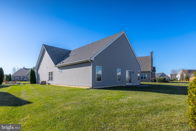 view of side of home featuring central air condition unit and a lawn