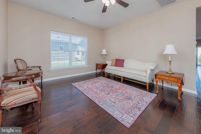 living room with ceiling fan and dark hardwood / wood-style flooring