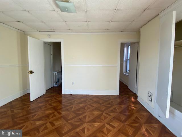 empty room featuring dark parquet flooring