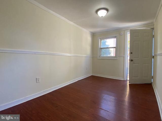 foyer featuring dark hardwood / wood-style floors and crown molding