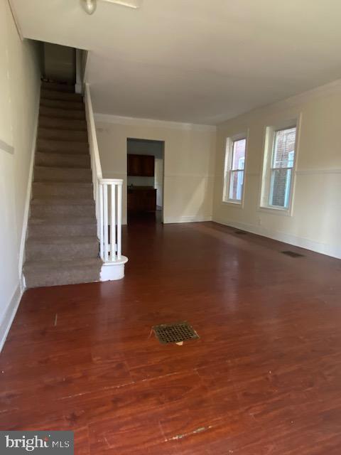 unfurnished room with dark hardwood / wood-style floors and ornamental molding