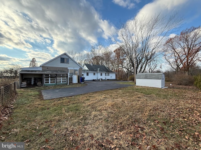 exterior space featuring a lawn and an outbuilding