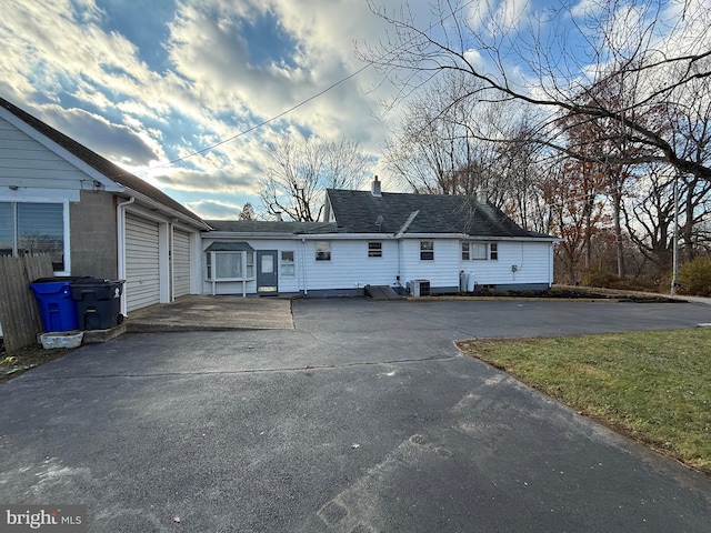 view of front facade featuring central AC unit and a garage