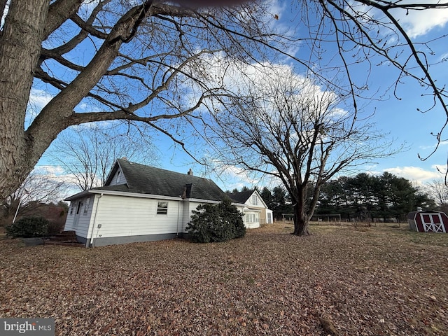 view of property exterior featuring a storage unit