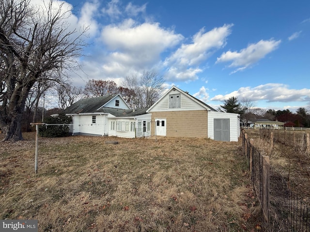 rear view of house with a yard