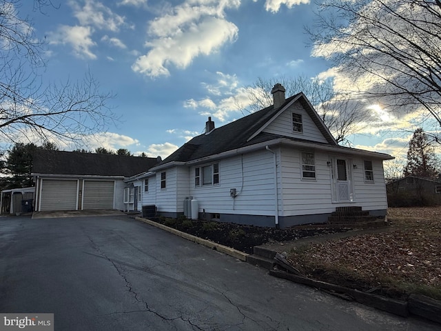 view of home's exterior with a garage and an outdoor structure