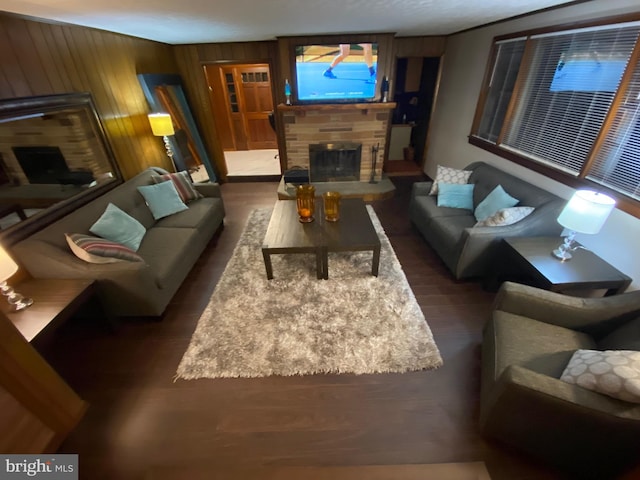 living room featuring wooden walls, a fireplace, and dark hardwood / wood-style floors